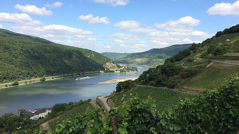 A river flows between green hills.